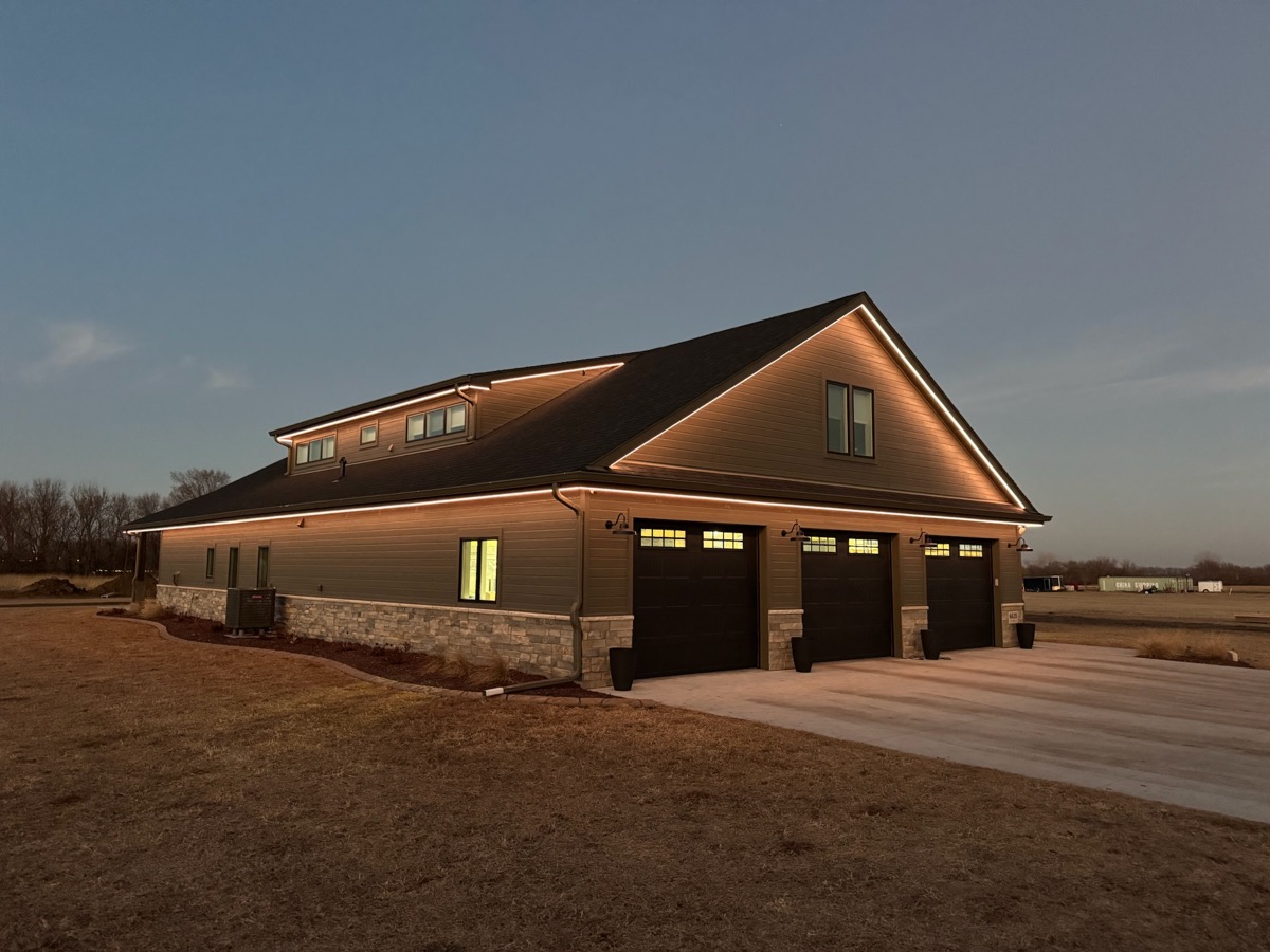 The same home at night with the roofline lighting fully illuminated